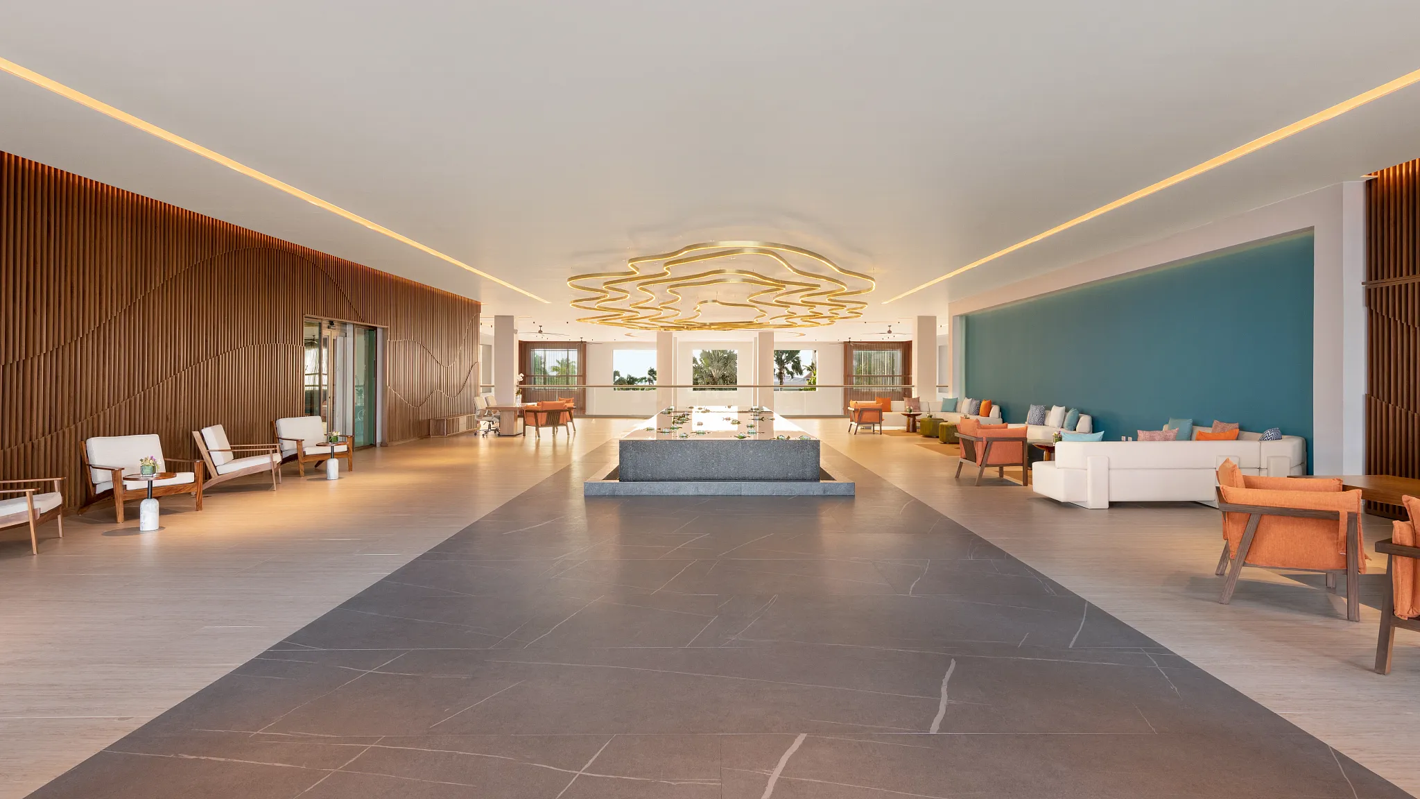 Grand hotel lobby with high ceilings and modern seating at Dreams Puerto Morelos Resort & Spa.