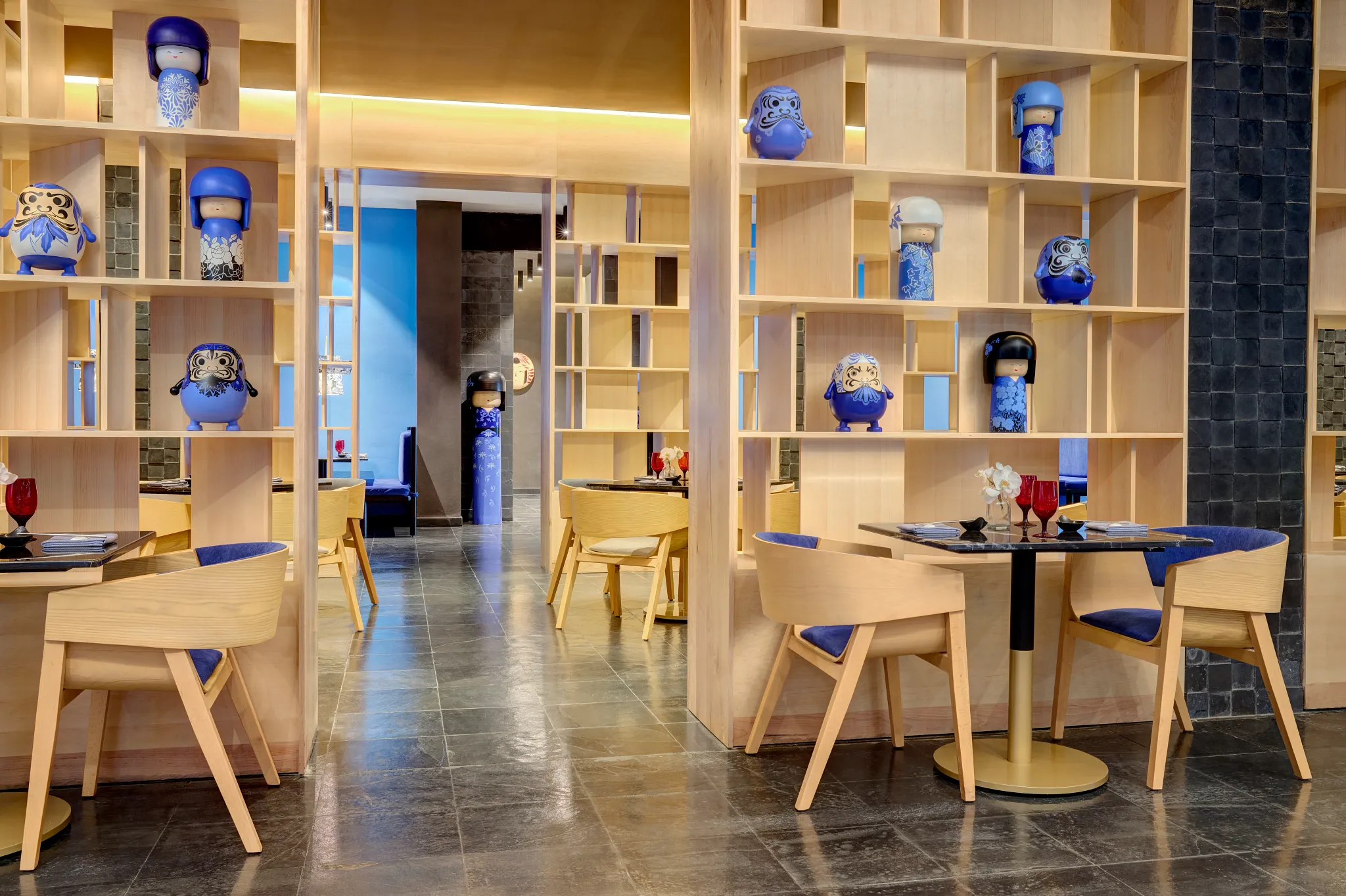 Miyako Asian restaurant at Dreams Puerto Morelos Resort & Spa featuring modern Japanese-inspired décor, wood accents, and intimate dining tables.