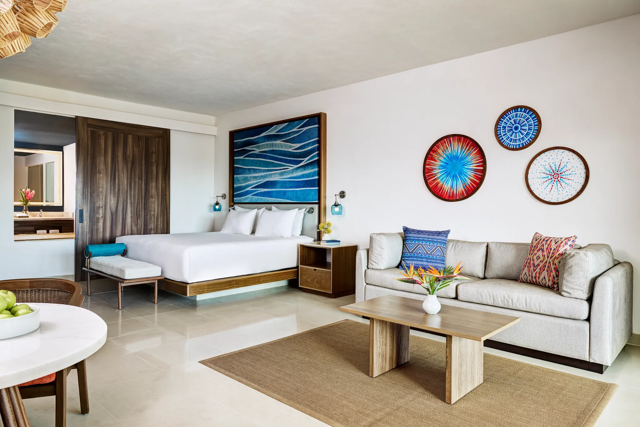 Preferred Club Junior Suite Ocean View with two double beds and modern seating area at Dreams Puerto Morelos Resort & Spa.
