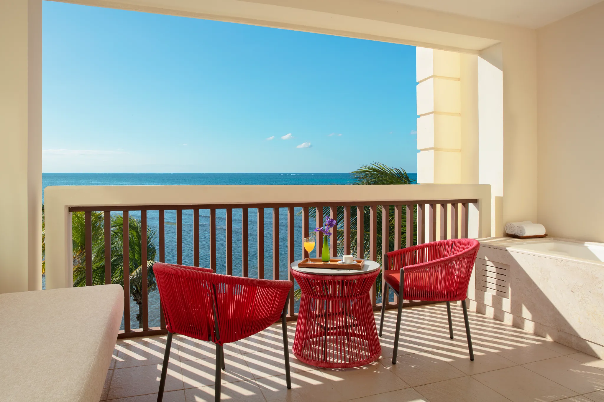 Preferred Club Master Suite Ocean Front balcony with ocean views and outdoor seating at Dreams Puerto Morelos.
