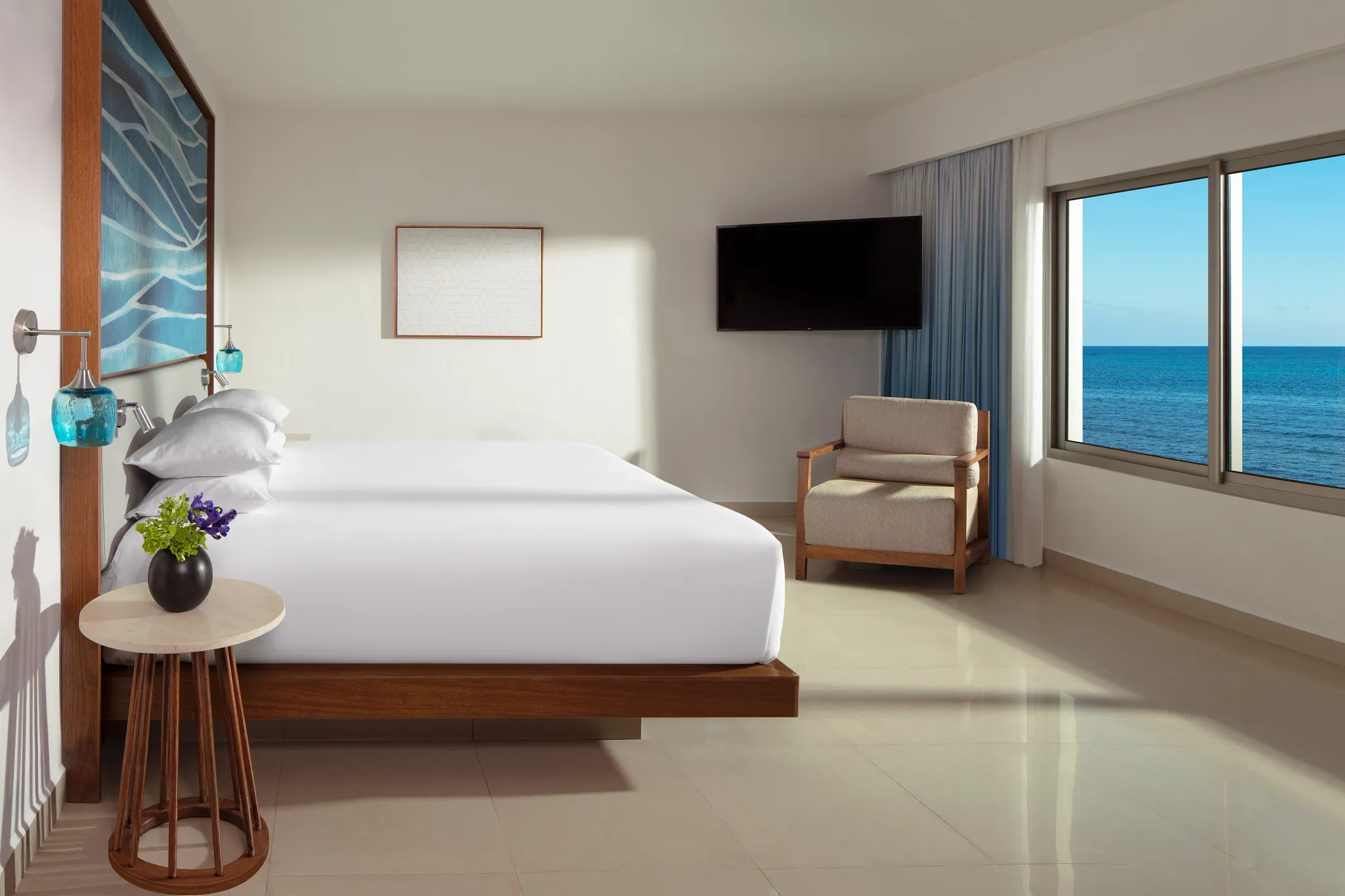 Preferred Club Master Suite Ocean Front bedroom with king bed and ocean view at Dreams Puerto Morelos Resort.
