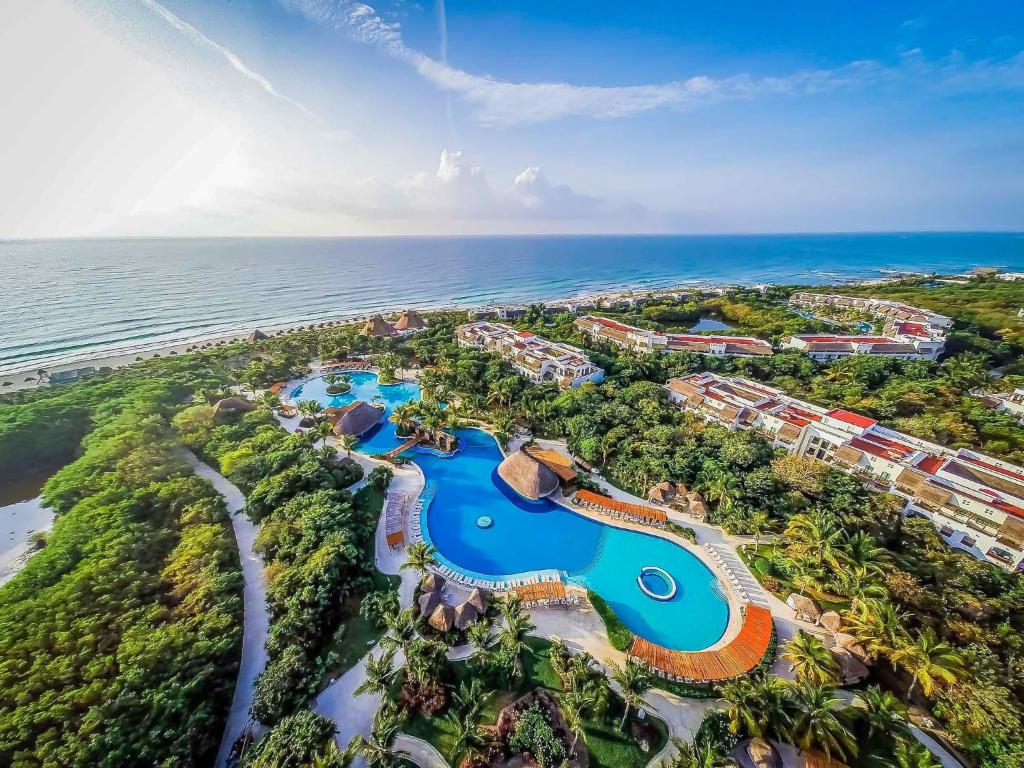 Valentin Imperial Riviera Maya adults-only all-inclusive resort with colonial-style architecture, beachfront pools, and tropical gardens.