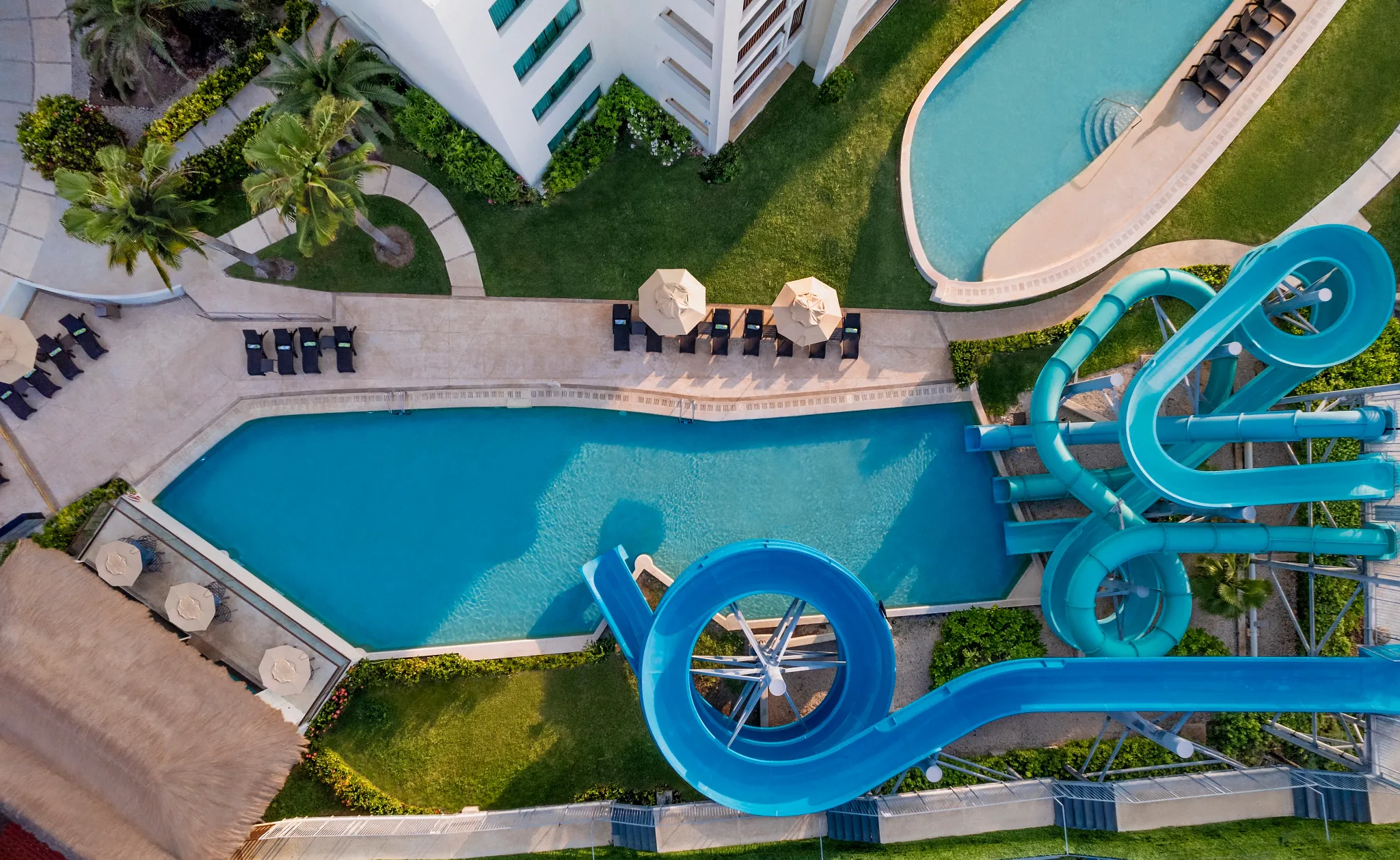 Overhead view of waterslides and family pool area at Dreams Puerto Morelos Resort & Spa.